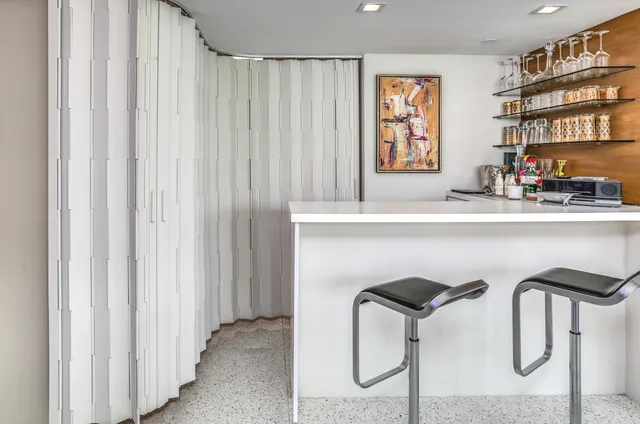 a view of living room with furniture and a potted plant