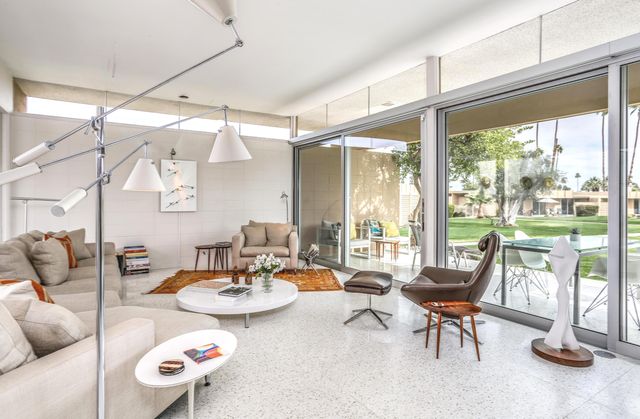 a dining room with furniture a floor to ceiling window and a table