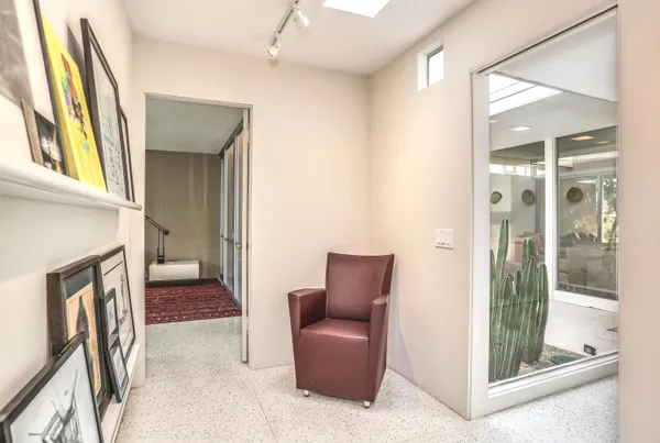 a view of a bedroom with furniture and large windows