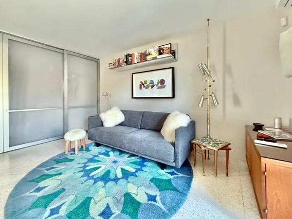 a living room with furniture and a rug