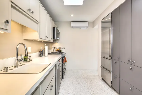 a kitchen with a sink and a refrigerator
