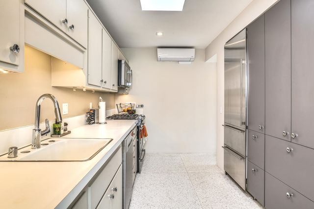 a kitchen with a sink and a refrigerator