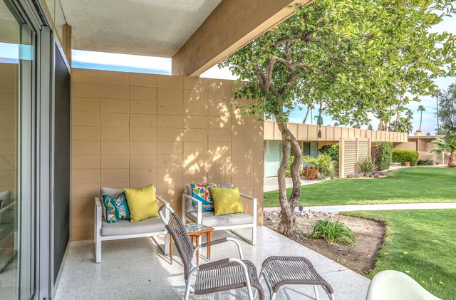 a view of a palm trees in the backyard of a house