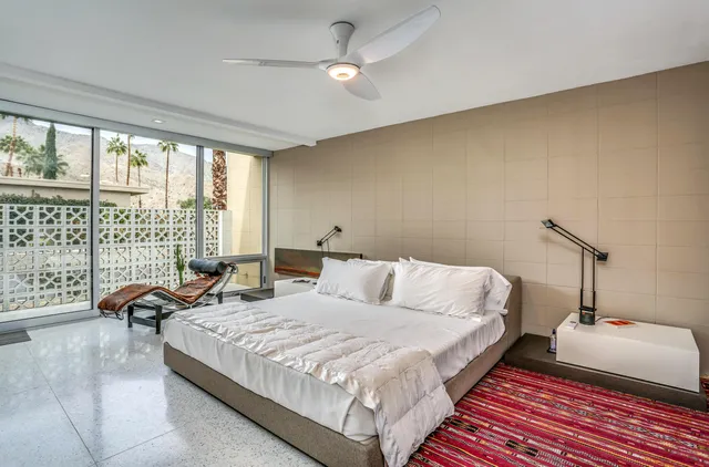 a bedroom with a bed and a couch