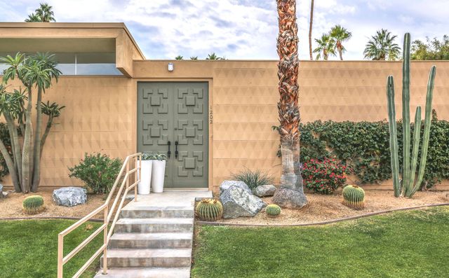 a view of a patio with table and chairs and potted plants