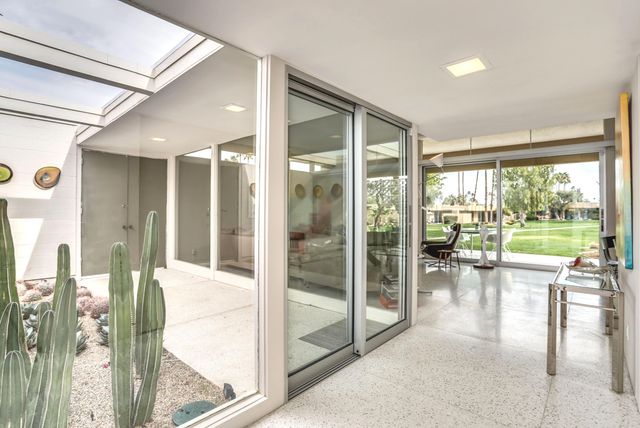 a lobby with furniture and floor to ceiling window