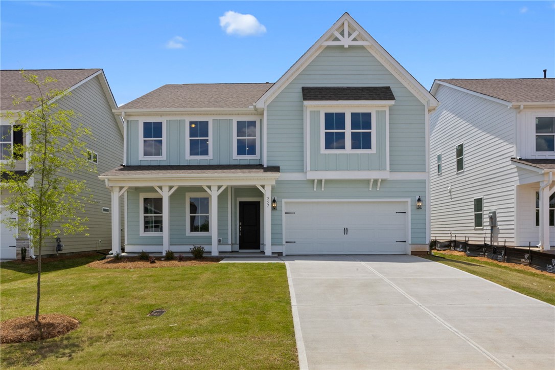 Two-story home with a pristine façade and an attached garage.