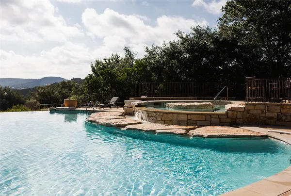a view of a house with swimming pool and sitting area