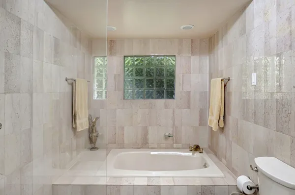 a white toilet sitting next to a bathroom sink