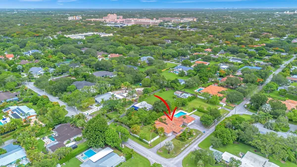 an aerial view of a house with garden space and a street view