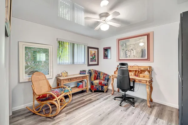 a view of a workspace with furniture and a window