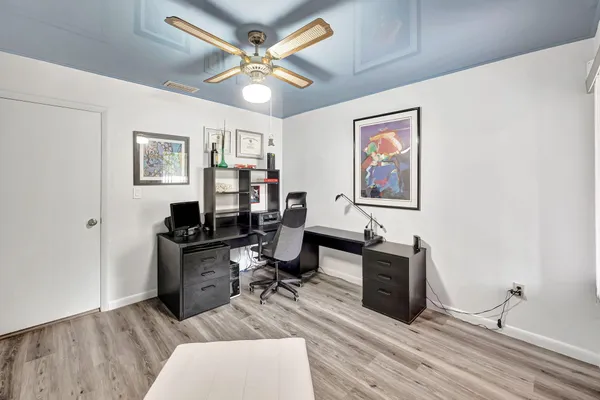 a living room with furniture and wooden floor