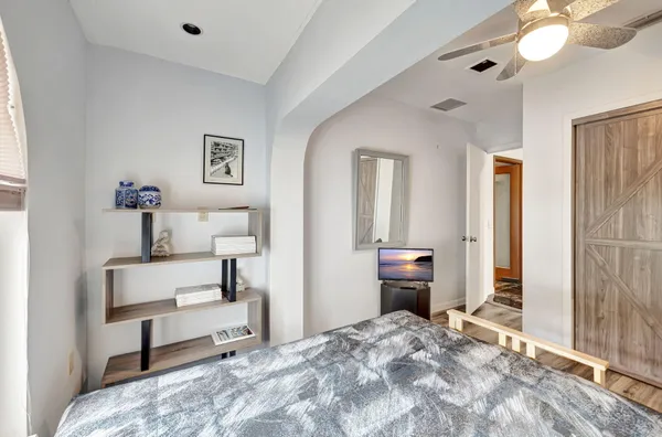 a kitchen with a stove and a wooden floor