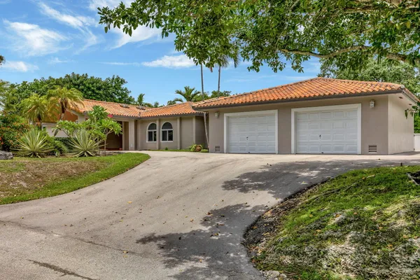 a view of a dining room with furniture a chandelier and wooden floor