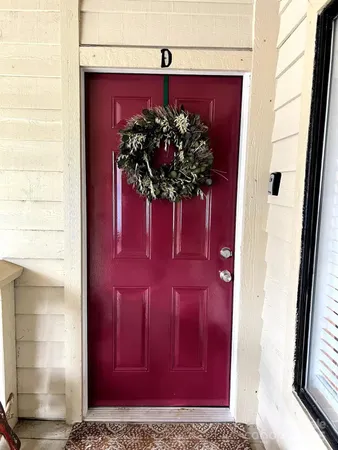 a vase of flowers sitting on a glass door