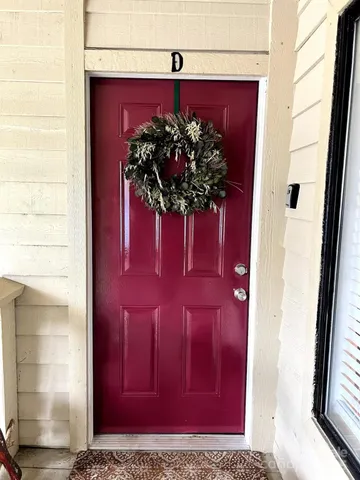 a vase of flowers sitting on a glass door