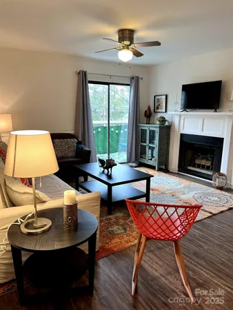 a living room with furniture a fireplace and a flat screen tv