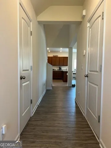 a view of a hallway view with wooden floor and furniture