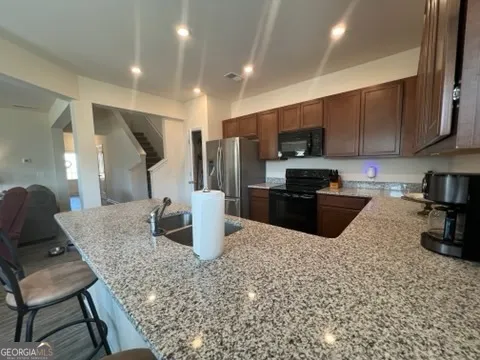 a kitchen with a stove a sink and a refrigerator