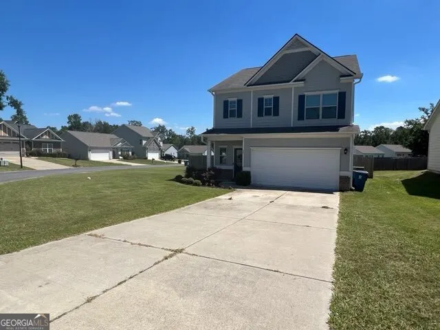 a front view of a house with a yard