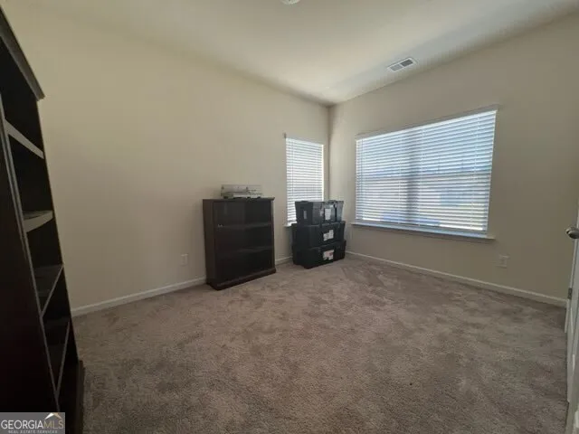 an empty room with furniture and window