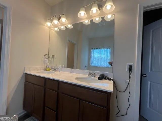 a bathroom with a sink vanity and a mirror