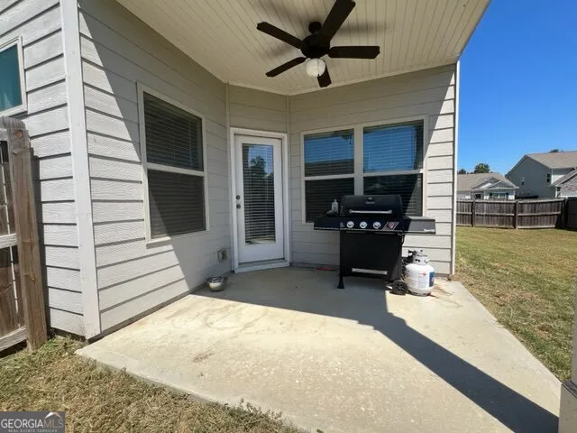 a view of a porch with a table and chairs