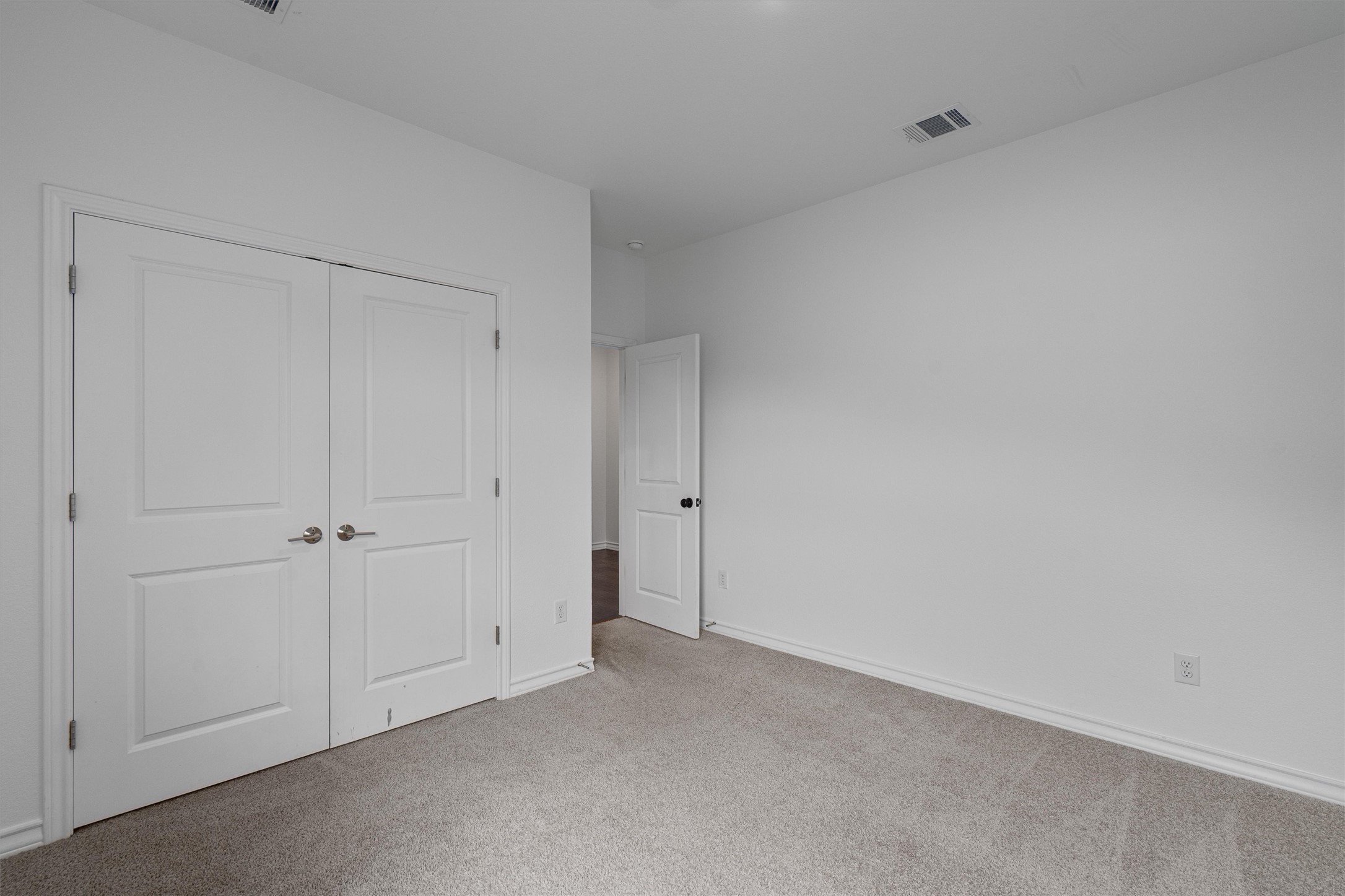 104 Stinchcomb Road Hutto, TX 78634 - Photo 25 of 40 Bedroom 3 is also located at the front of the home and features a walk-in closet, making it a comfortable and functional secondary bedroom. It sits near the full bathroom shared with Bedroom 2.