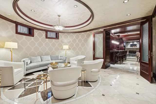 a spacious bedroom with a bed and a dresser with mirror