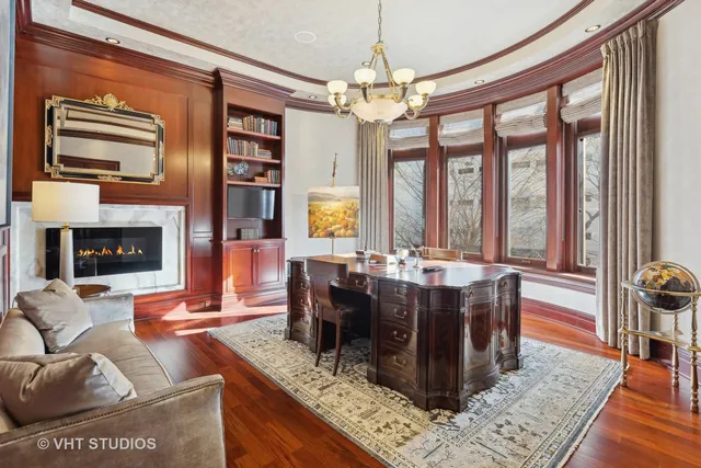 a bedroom with a large bed and a chandelier