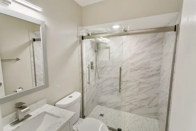 a view of a room with wooden floor and white walls