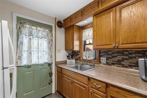 a kitchen with a window a sink and cabinets