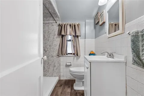 a bathroom with a sink toilet and shower