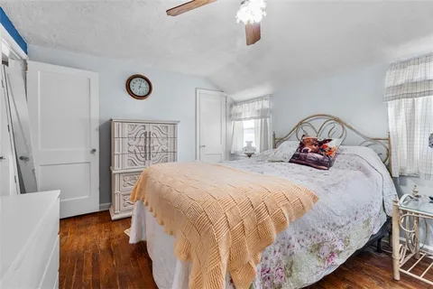 a bedroom with a bed and a large mirror