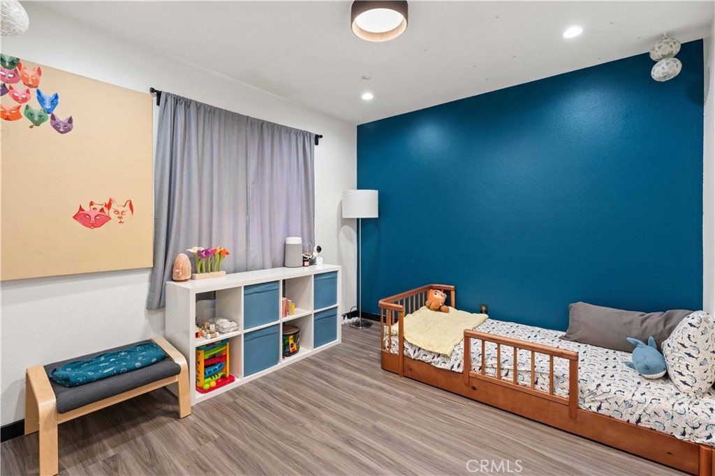 5363 Cornwall Avenue Riverside, CA 92506 - Photo 13 of 23 a bedroom with furniture and a book shelf