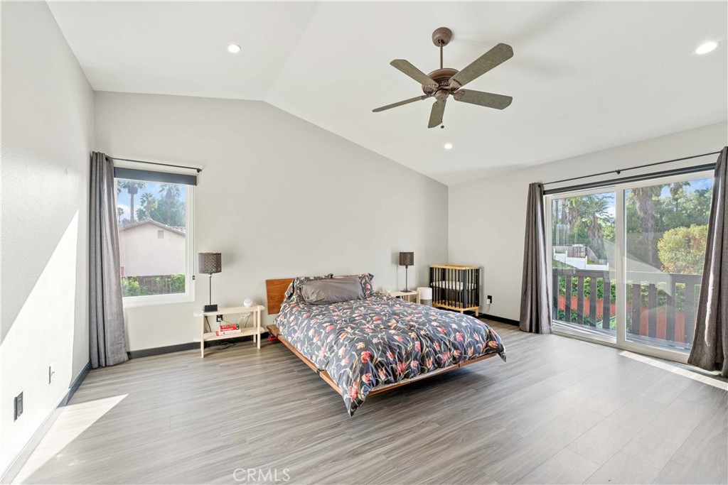 5363 Cornwall Avenue Riverside, CA 92506 - Photo 10 of 23 a bedroom with a bed and a large window with wooden floor