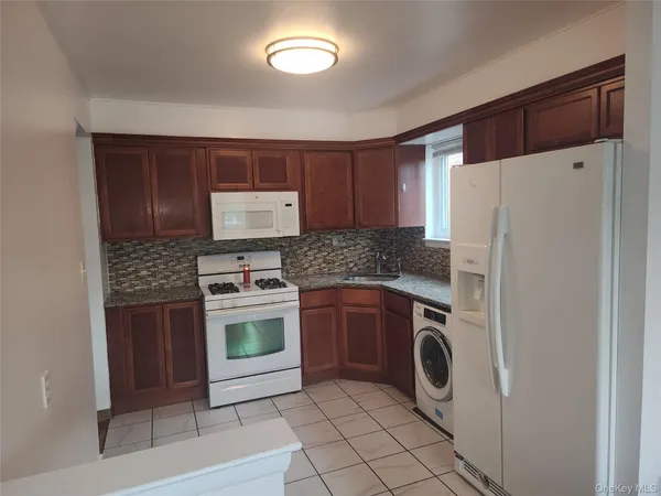 a kitchen with a refrigerator sink and stove