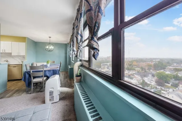 a view of a city from a dining room with furniture