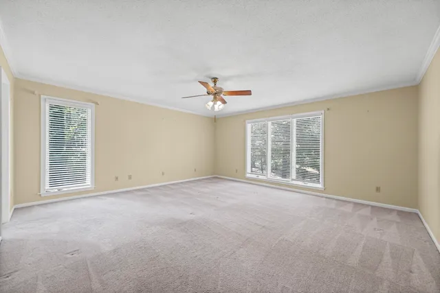 a view of a livingroom with a ceiling fan and window