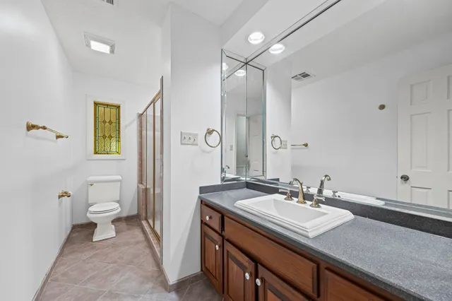 a bathroom with a sink double vanity and a toilet