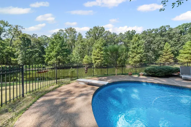 a view of a swimming pool and a yard