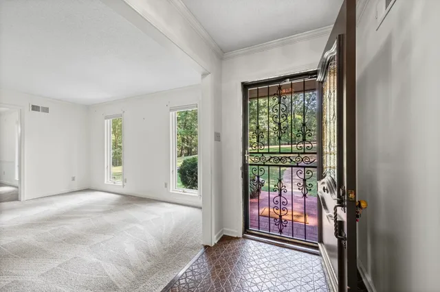 a view of an empty room with glass door