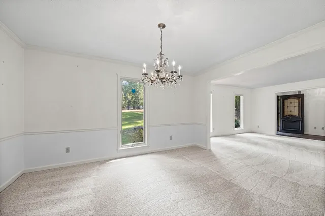 a view of a chandelier and window in the room
