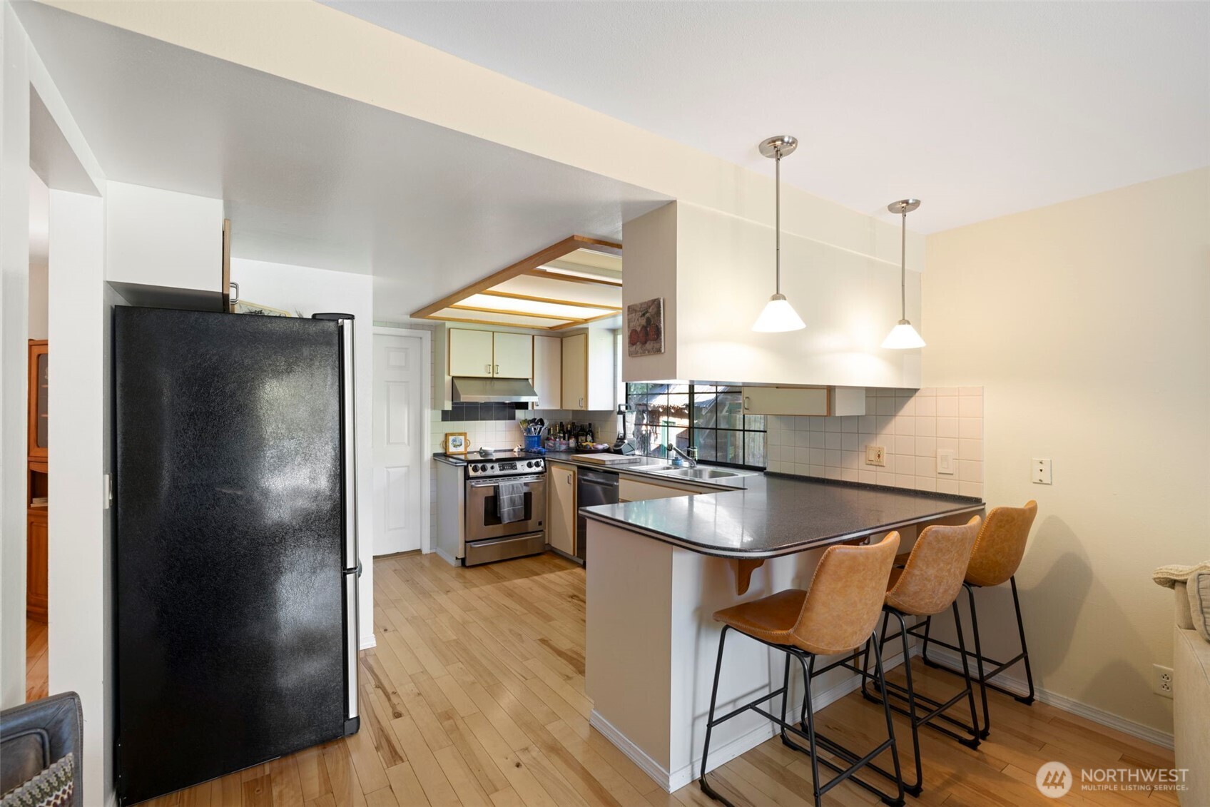 834 Cary Road Edmonds, WA 98020 - Photo 14 of 40 a kitchen with stainless steel appliances granite countertop a refrigerator a sink a stove and a refrigerator