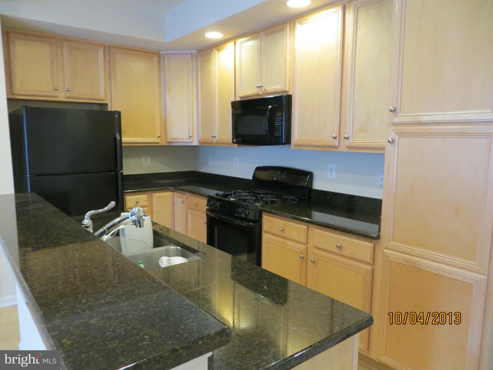 1826 Monocacy View Circle, Unit 50A Frederick, MD 21701 - Photo 3 of 6 a kitchen with stainless steel appliances granite countertop a sink a stove and a refrigerator