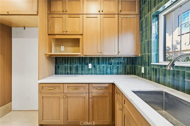 a kitchen with kitchen island a counter top space and a sink
