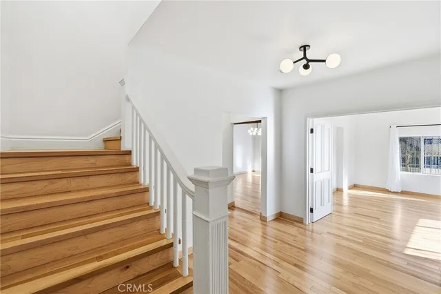a view of entryway and hall with wooden floor