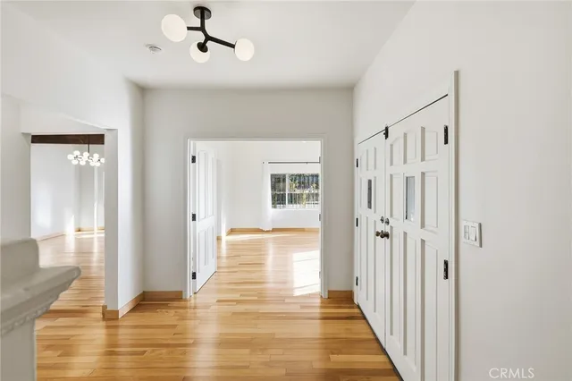 a view of a hallway with wooden floor and staircase