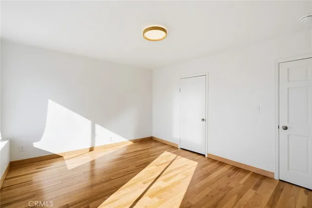 a view of a room with wooden floor and window