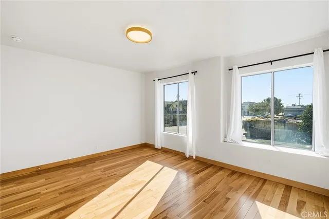 a view of a room with wooden floor and window